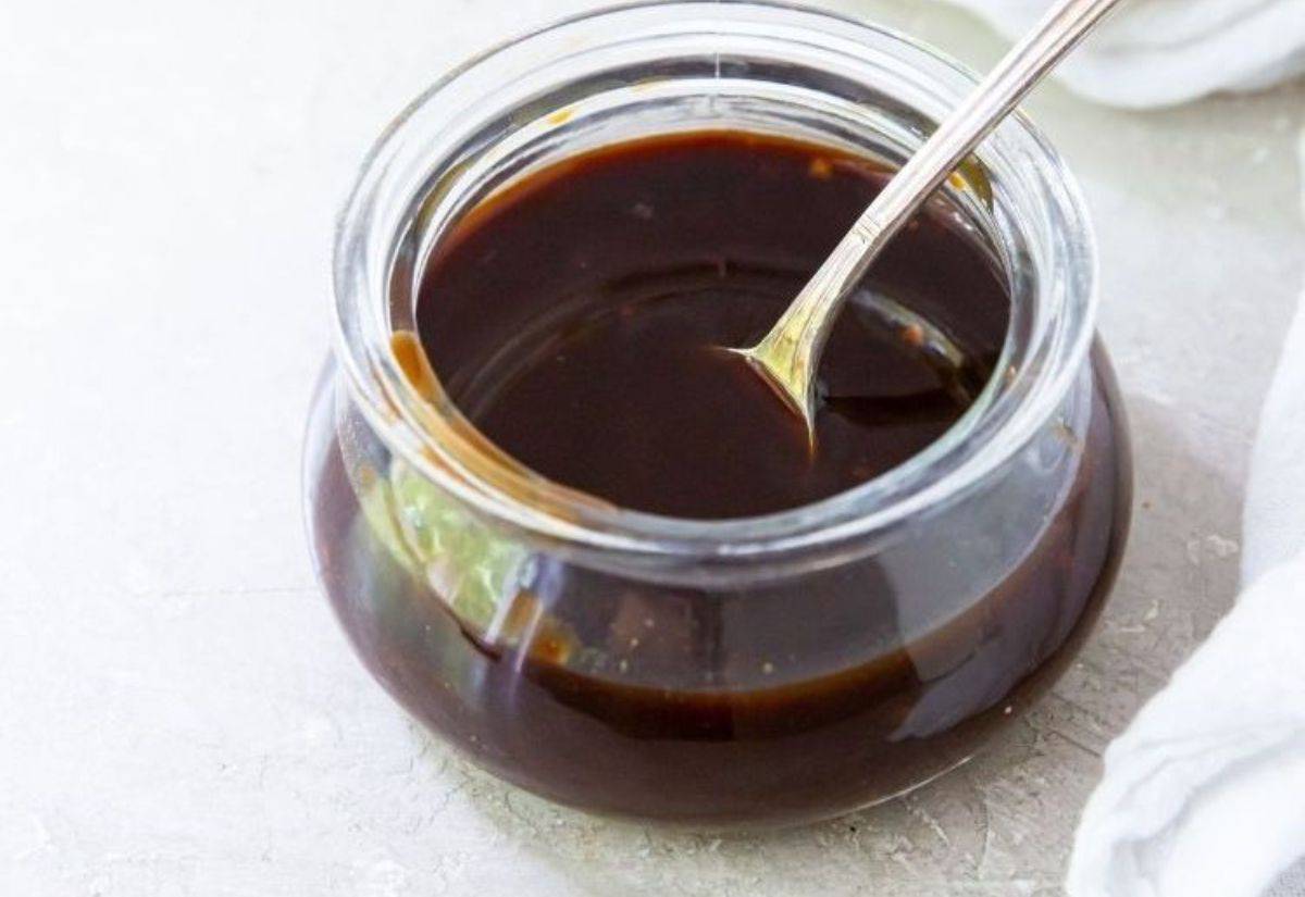 Honey Teriyaki Sauce Recipe (Paleo & Gluten-Free) in a glass jar with a spoon.
