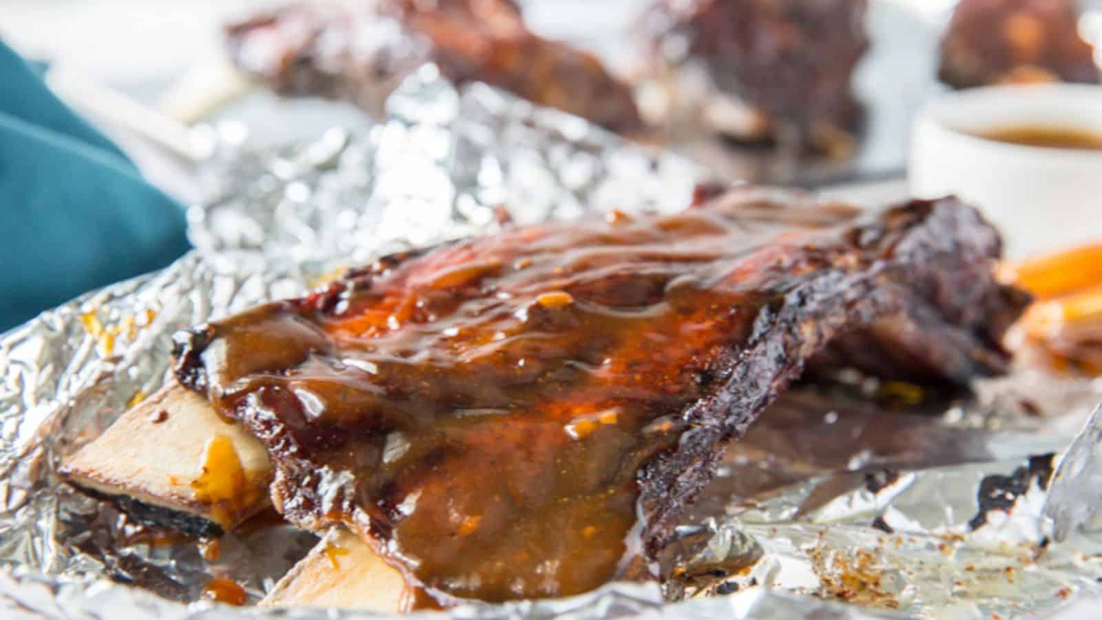 Instant Pot Ribs- Fall Off the Bones Beef Ribs Low Carb, Gluten-Free on foil with a basting brush and bbq sauce.