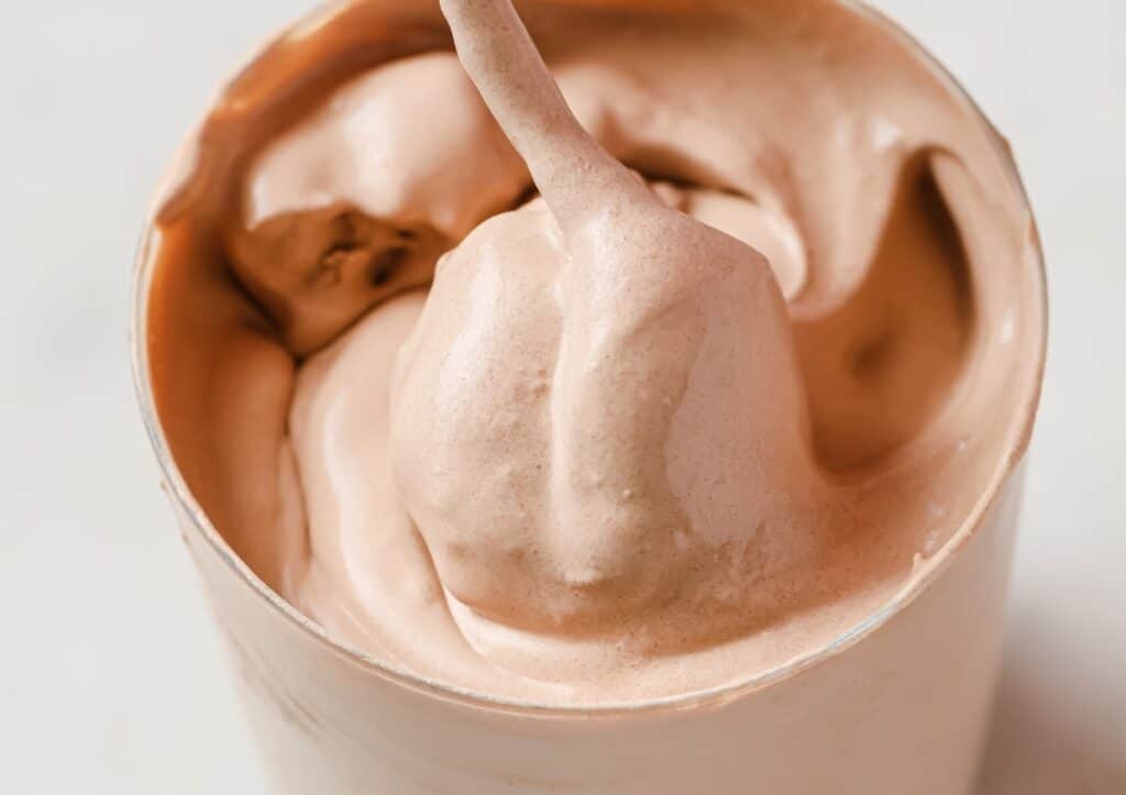 Close-up of a swirled chocolate soft-serve frosty in a cup.