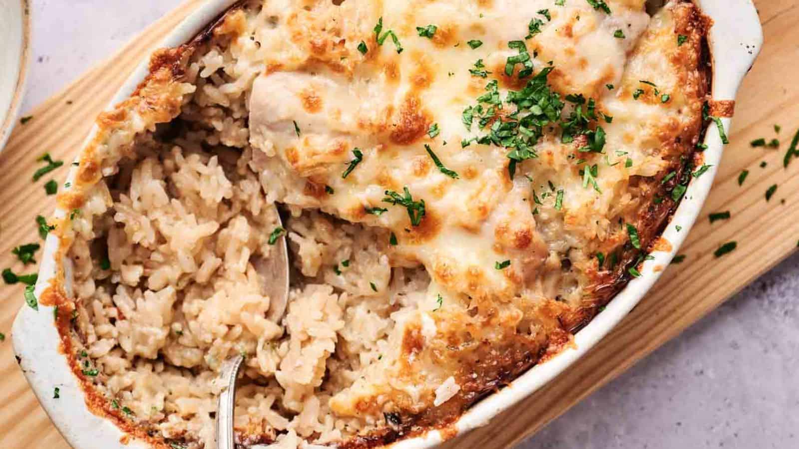 A baked rice casserole topped with melted cheese and garnished with chopped herbs.