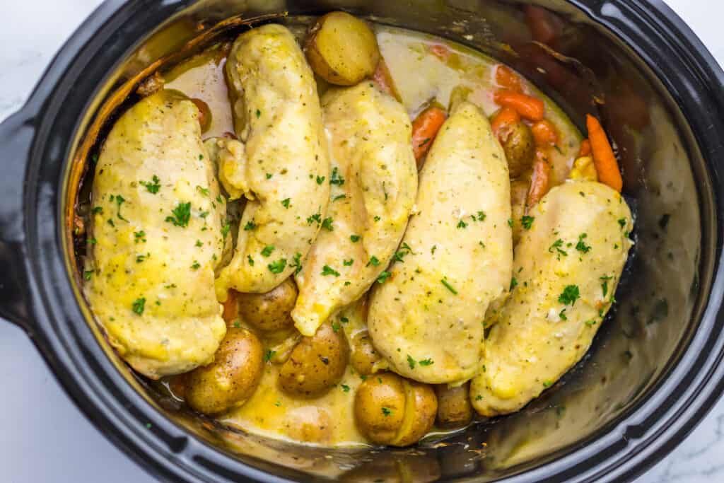 Chicken and vegetables in a slow cooker.