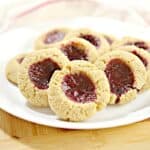Thumbprint cookies on a white plate.