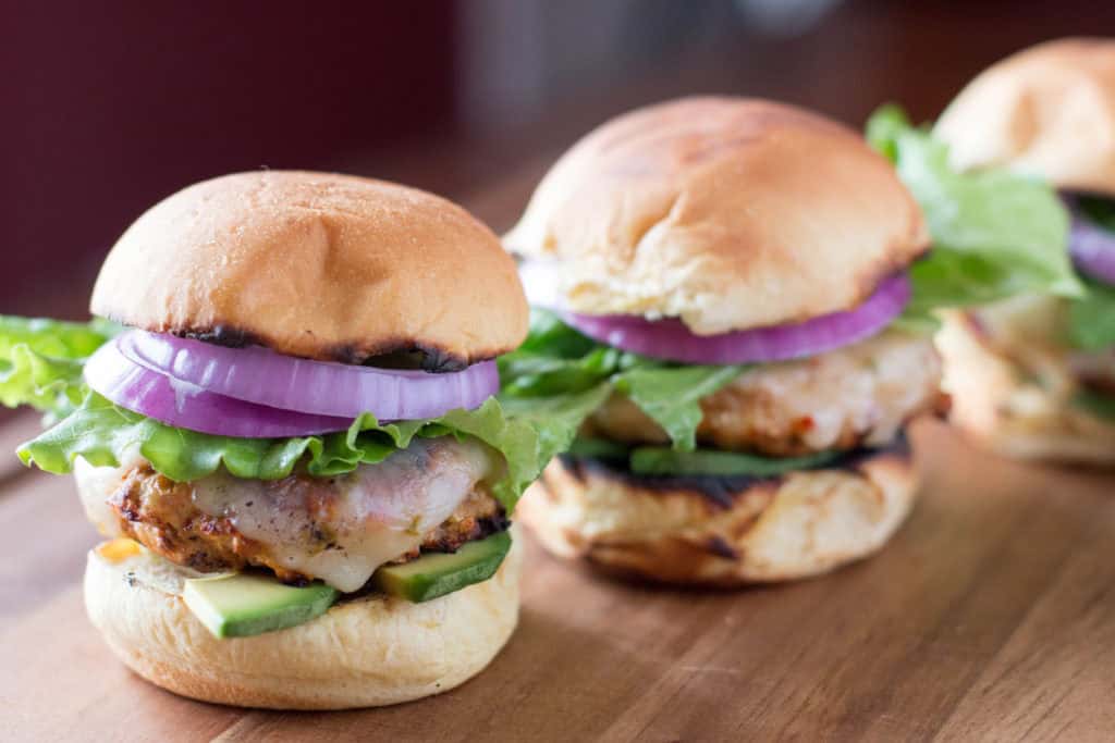 Turkey Sliders with cheese, red onion, avocado, and lettuce.