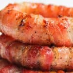 Stack of bacon wrapped onion rings.