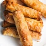 A plate of freshly cooked Filipino banana turon lumpia spring rolls.