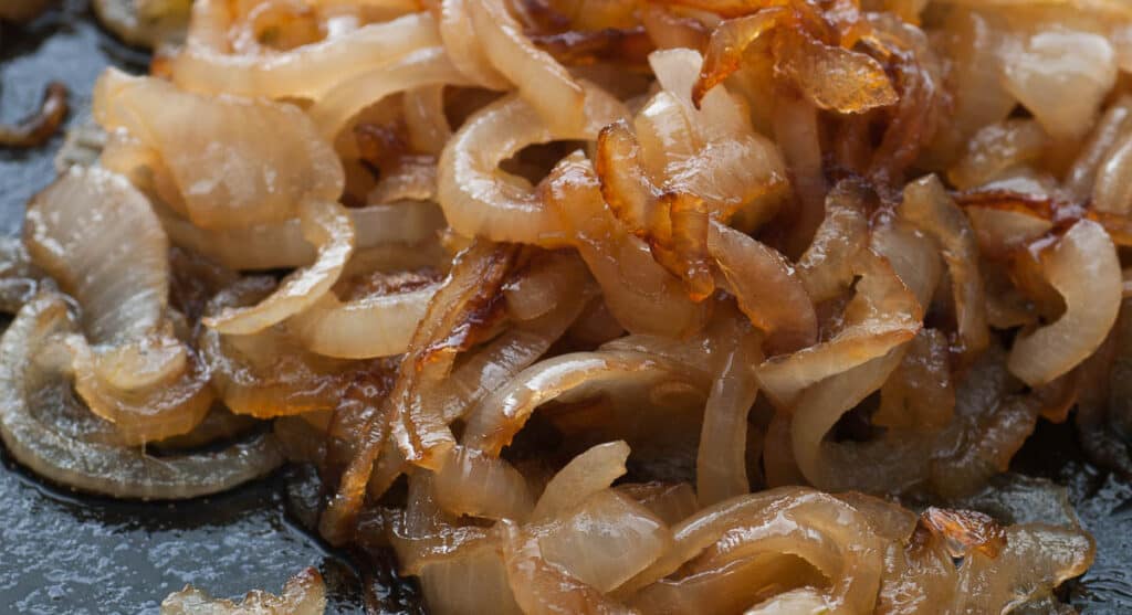 Caramelized onions on a cooking surface.
