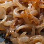 Caramelized onions on a cooking surface.