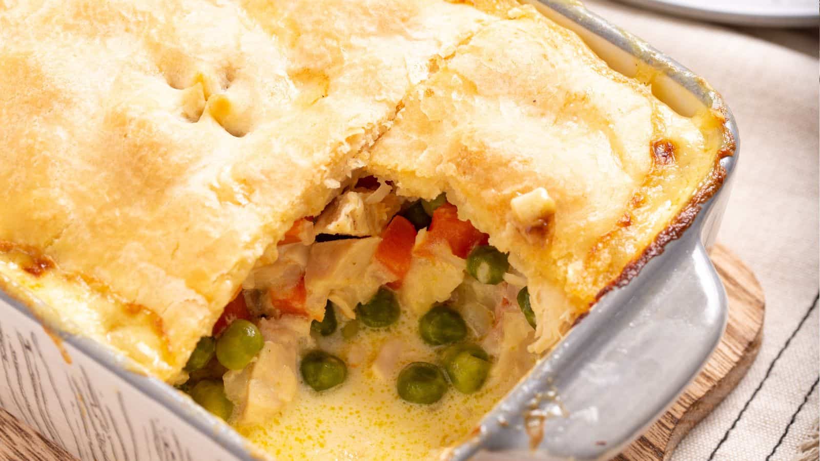 Small serving of chicken pot pie casserole on plate with fork.