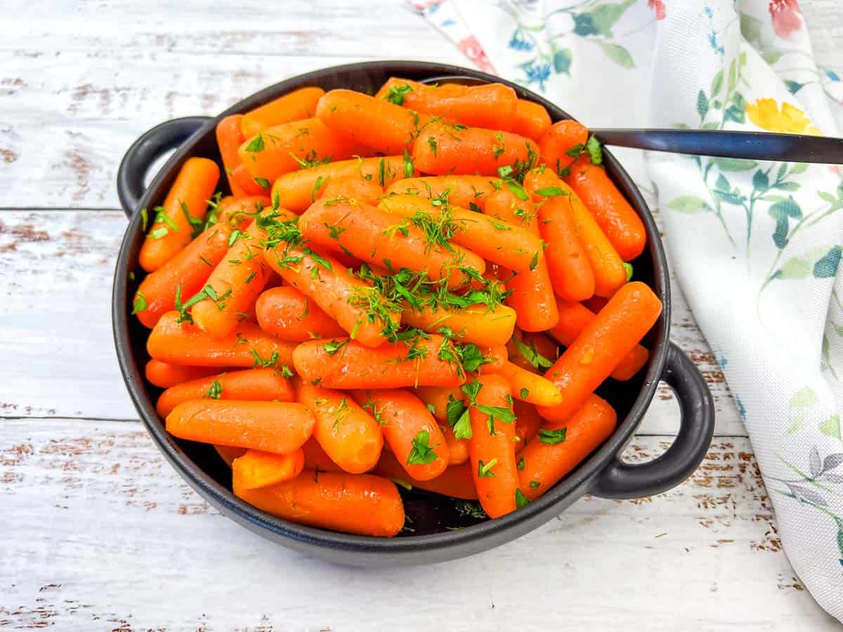 A bowl of Copycat Cracker Barrel Baby Carrots in a bowl.