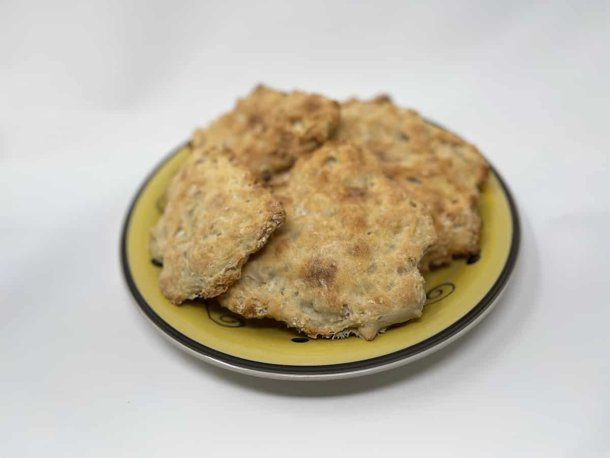 A plate of fried flatbreads on a white background.