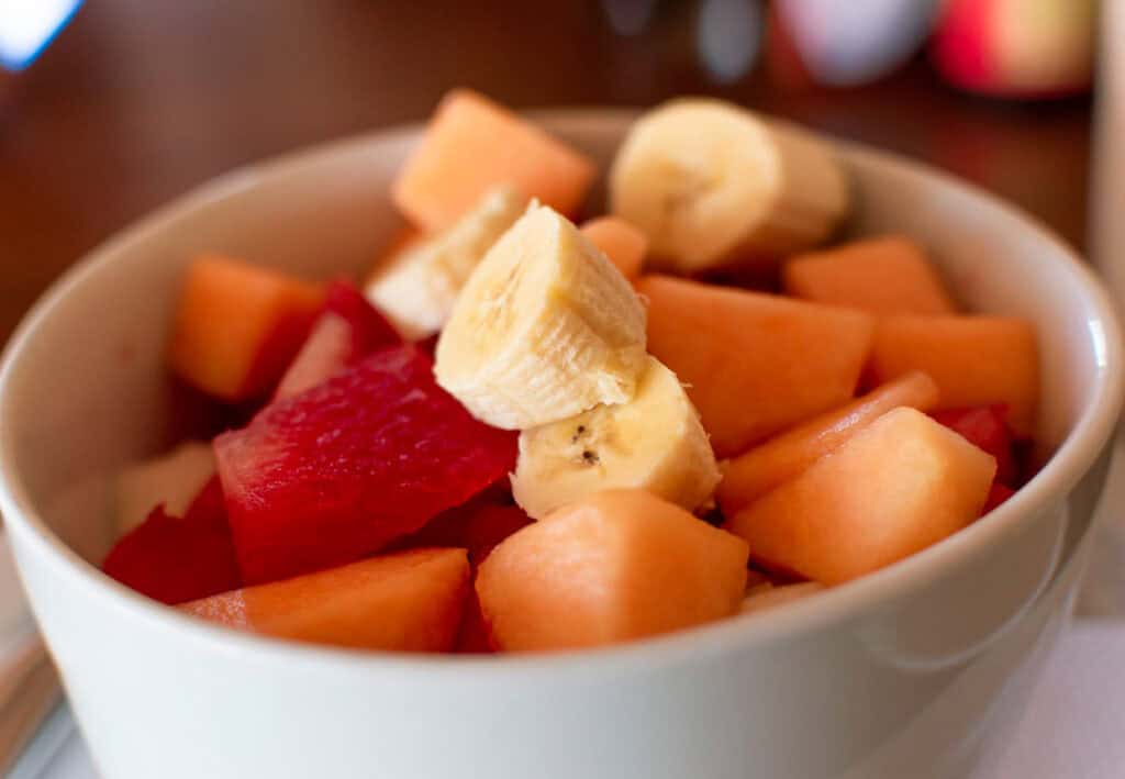 A bowl filled with chunks of banana, watermelon, and cantaloupe makes a refreshing breakfast for dinner.