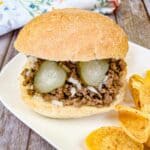 Copycat Maid-Rite Loose Meat Sandwich on a white plate with chips.