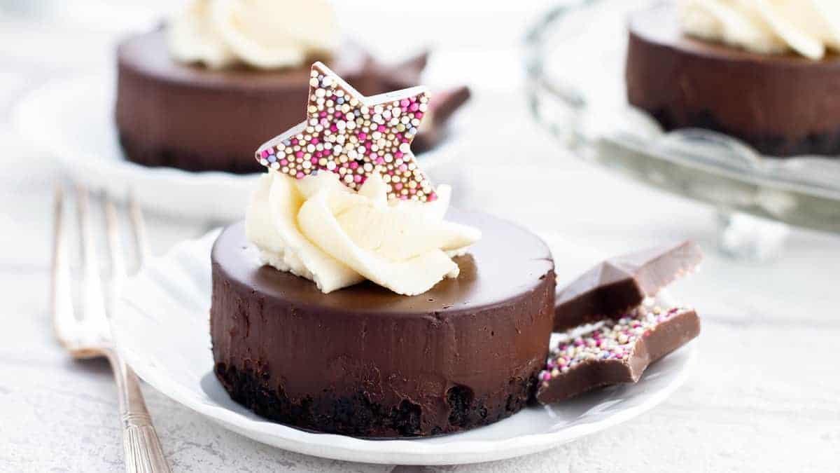 A chocolate dessert topped with whipped cream and a chocolate star.