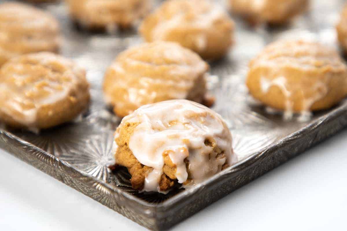 Spiced German cookies on a baking tray drizzled with glaze.