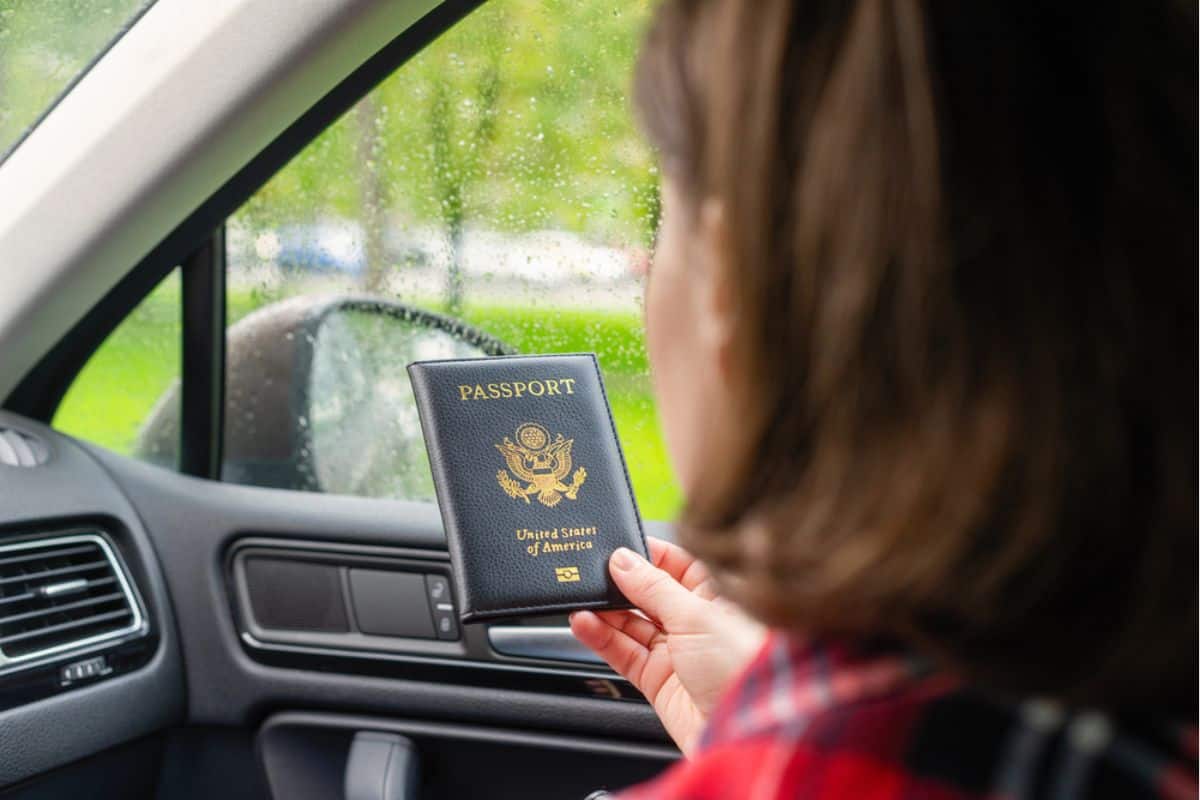 A woman showing her passport for border check-in checkpoint.
