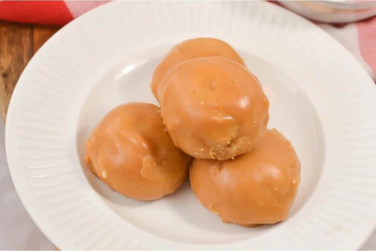 Peanut butter donut holes on a white plate.