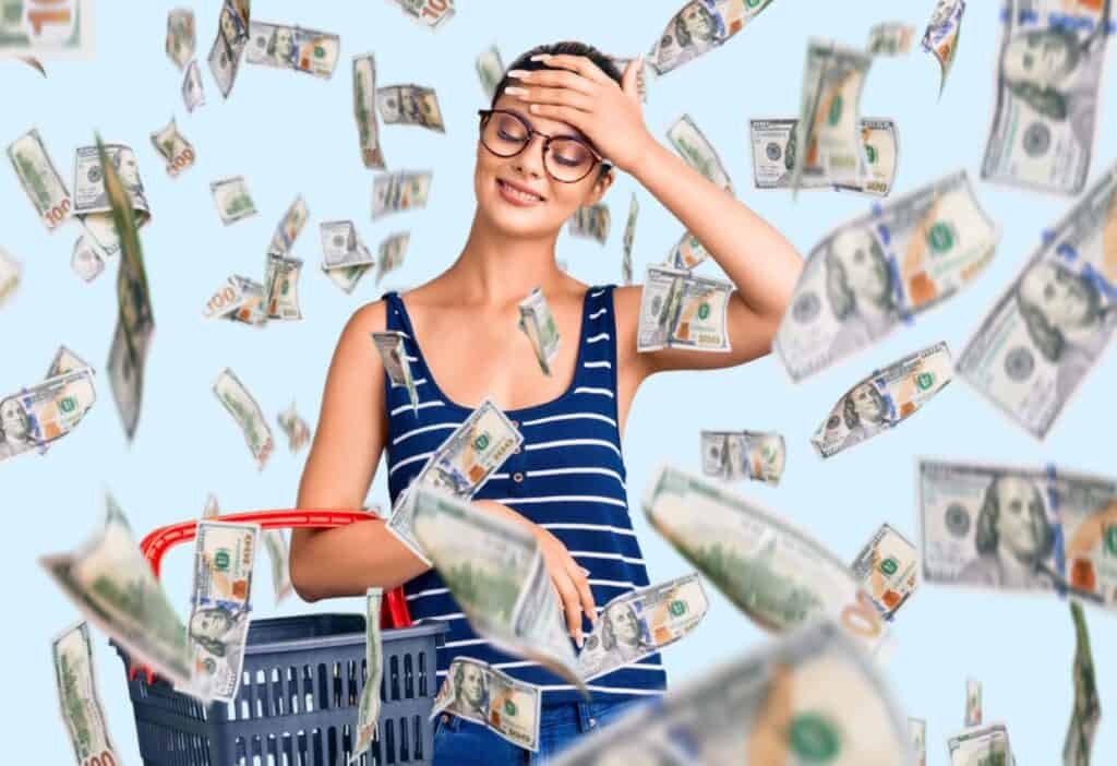 A person wearing glasses and a striped shirt smiles while holding a shopping basket, as hundred-dollar bills rain down around them.