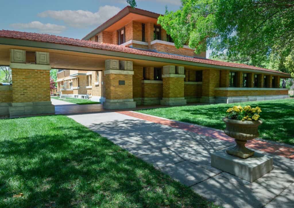 A brown brick home designed by Frank Lloyd Allen Wright that showcases the horizontal lines of his prairie design.