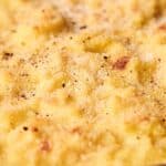 A close-up view of a baked macaroni and cheese casserole with a golden, crispy breadcrumb topping.