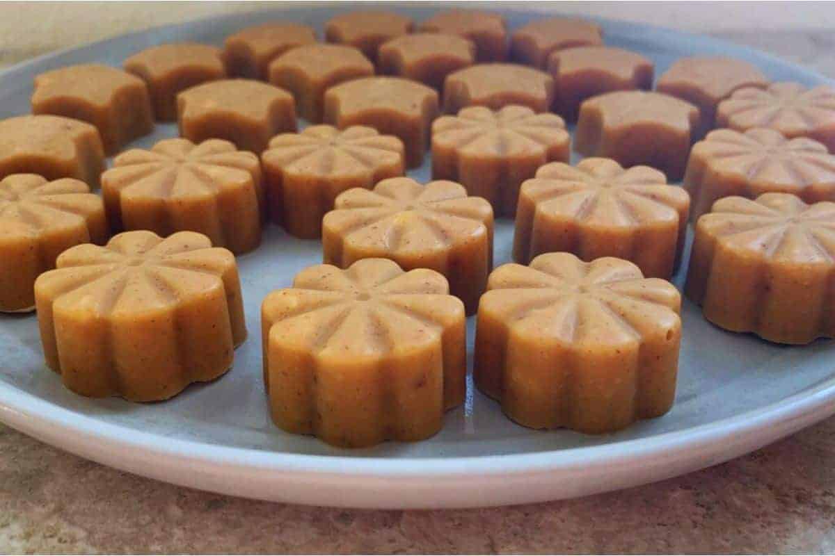 A plate of peanut butter bites on a table.