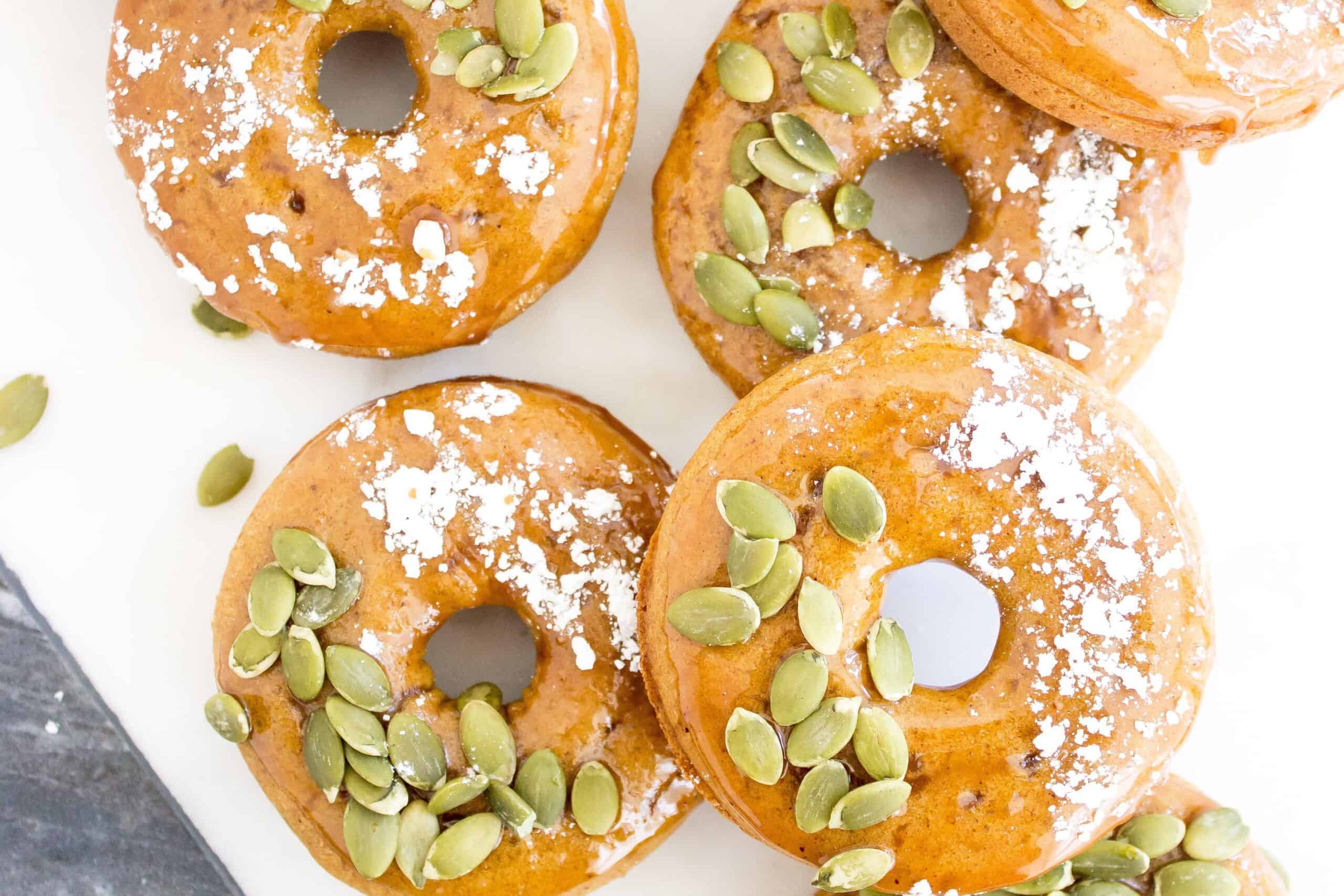 Donuts with pumpkin seeds and powdered sugar.