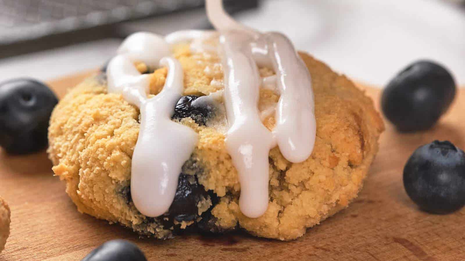 A blueberry scone drizzled with white icing.