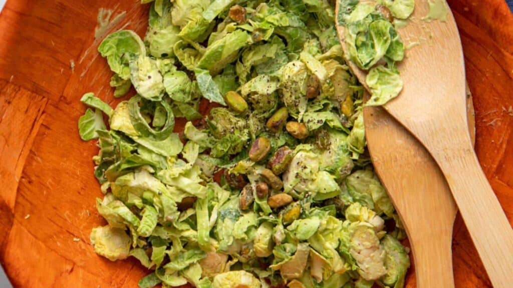 An overhead image of Vegan Caesar Salad with Shaved Brussels Sprouts in wooden bowl.