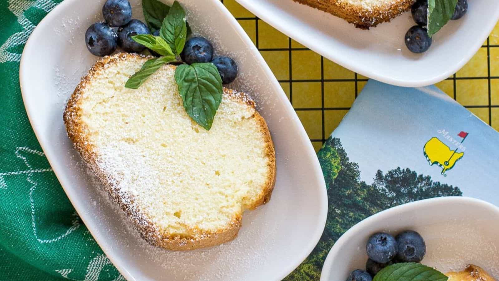 A slice of Augusta National Sour Cream Pound Cake with a dusting of powdered sugar.