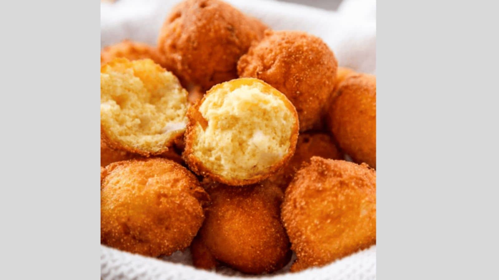 A basket of hushpuppies lined with a paper towel.