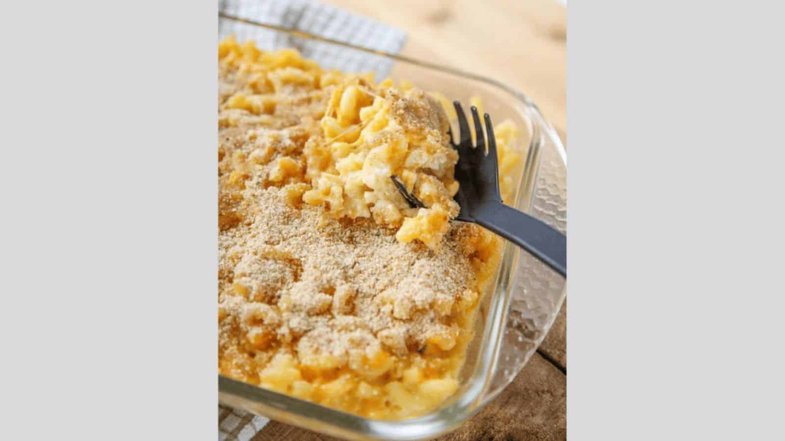Baked macaroni and cheese topped with breakcrumbs in a casserole dish.