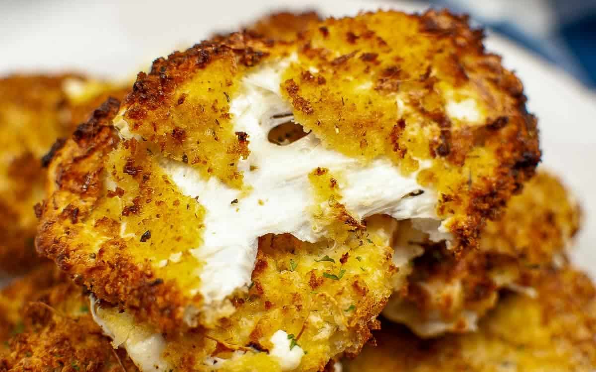 Close-up of golden-brown, crispy fried mozzarella.