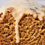 Close-up of a glazed loaf of banana bread, highlighting its moist texture and golden brown color.