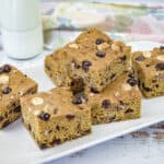 A white rectangular plate with pieces of pumpkin blondies.