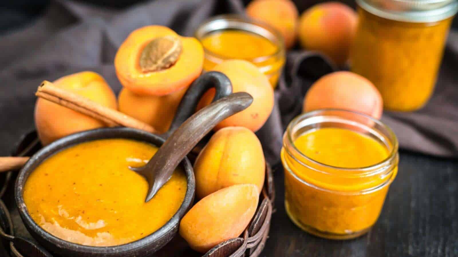 Jars and a bowl of apricot jam.