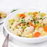 A bowl of homemade chicken soup with dumplings.