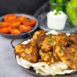 A plate of seasoned and cooked chicken wings.