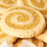 A close-up of a pile of swirl cookies with a light and dark pattern.