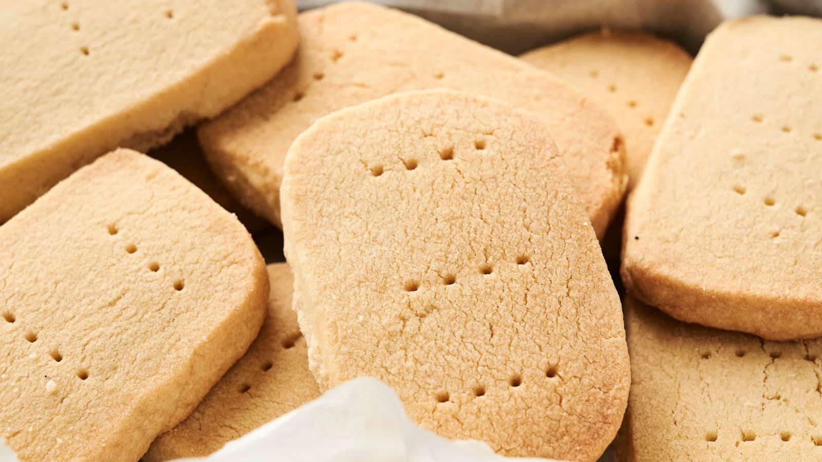 Close-up view of a pile of Shortbread Cookies with visible small holes on the surface.