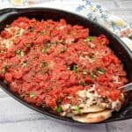 Shipwreck Casserole in a black dish with a spoon.