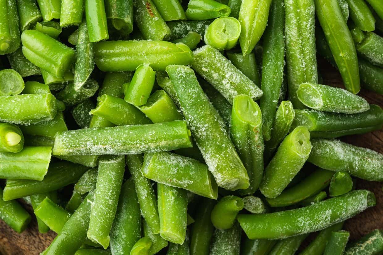 Close-up of a pile of frozen green beans.