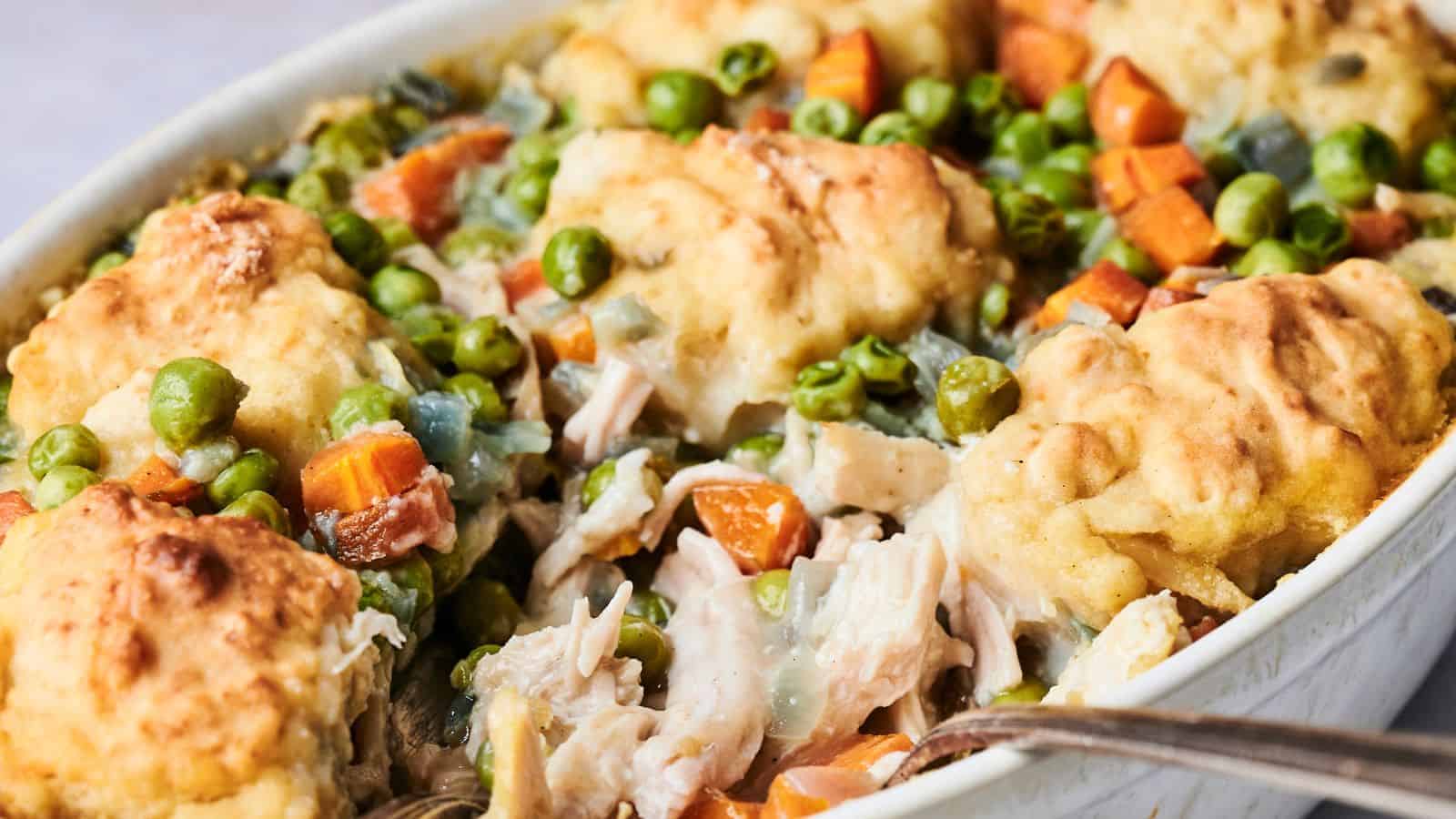 Experience the delightful Air Fryer Chicken and Dumpling Casserole, featuring baked dumplings alongside tender pieces of chicken, fresh peas, carrots, and a creamy sauce. This comforting dish combines classic flavors with modern convenience for a satisfying meal.