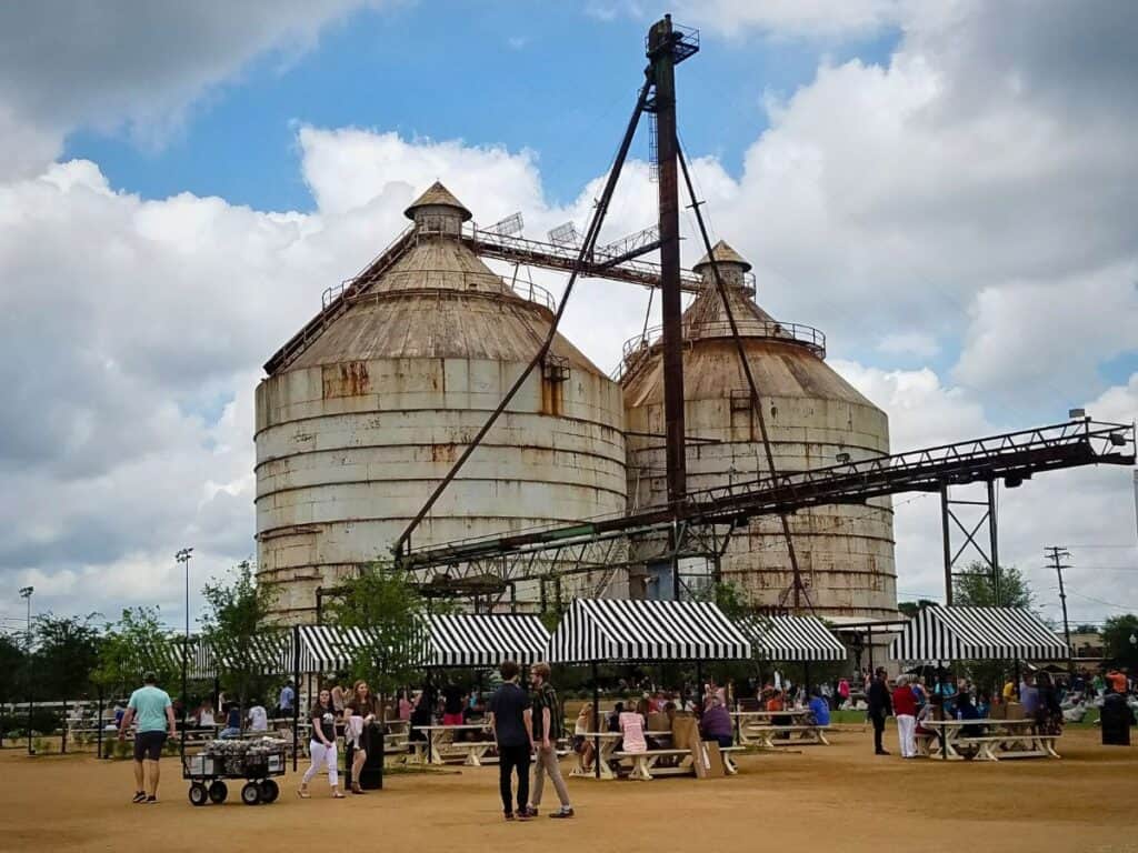 A crowd gathers at the Magnolia Market located near two large rusted silos in Waco, TX.