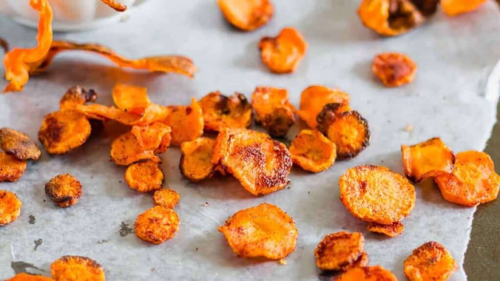 Slices of roasted sweet potatoes on parchment paper.