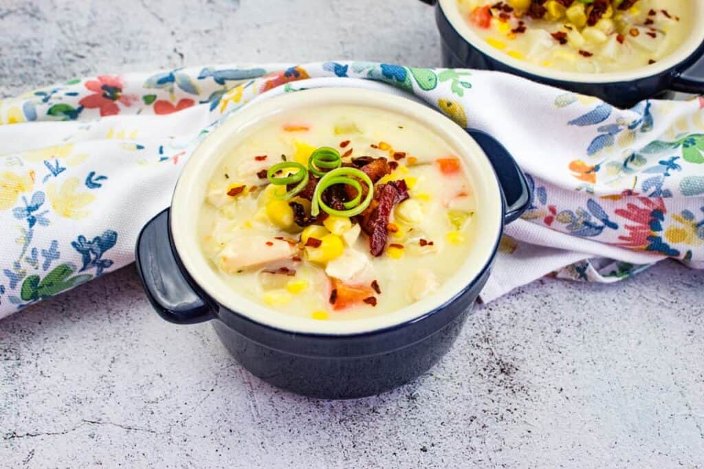 A bowl of Turkey & Corn Chowder garnished with the reserved crispy bacon.