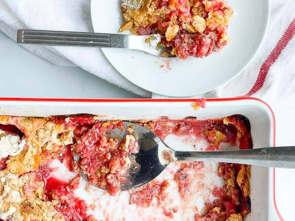 A pan with a scoops of cake dessert taked out.