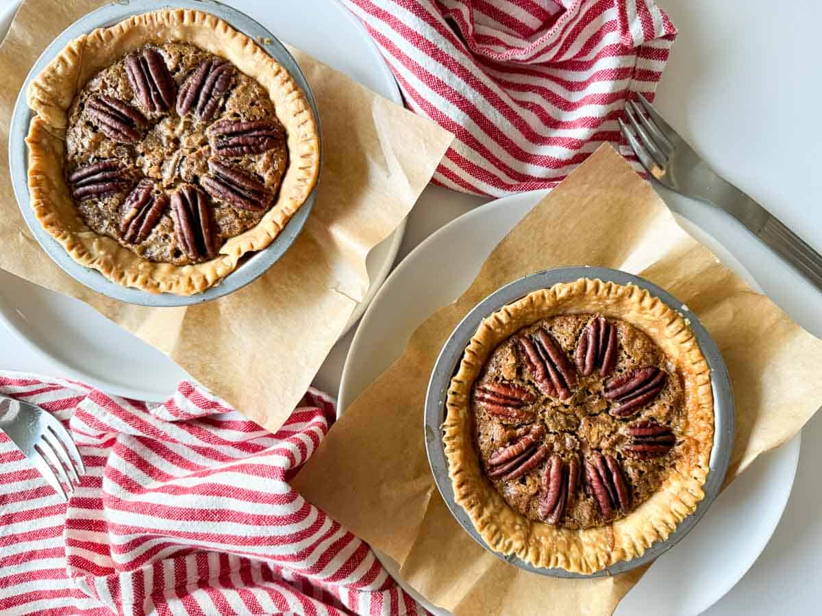 2 mini pecan pies on a table.