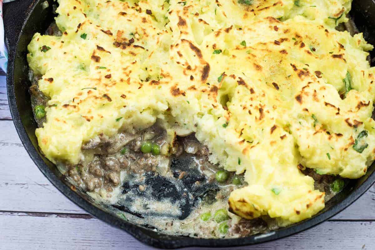 A Skillet Stroganoff Pie with a small missing portion.