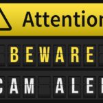 Yellow and black sign reading "Attention: Beware Scam Alert" with exclamation mark symbol.