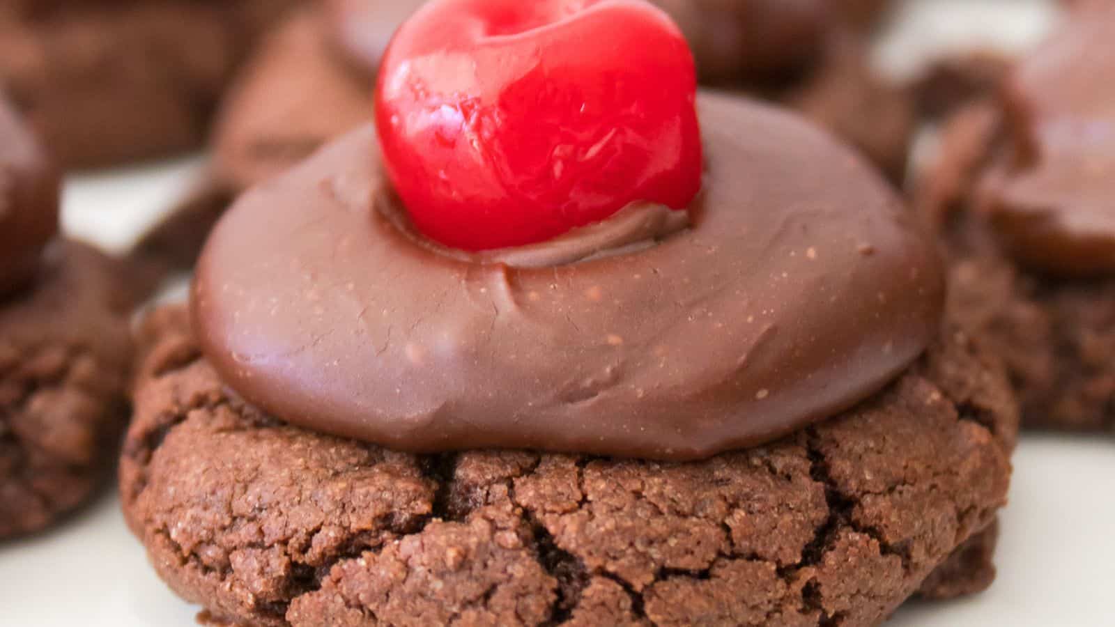 Enjoy our chocolate cherry cookies, each topped with a swirl of rich chocolate frosting and a vibrant red cherry.