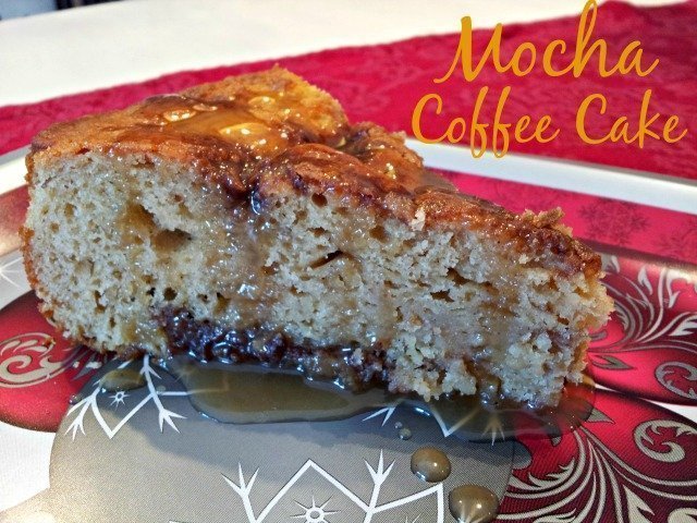 A slice of mocha coffee cake with a caramel drizzle on a festive plate.